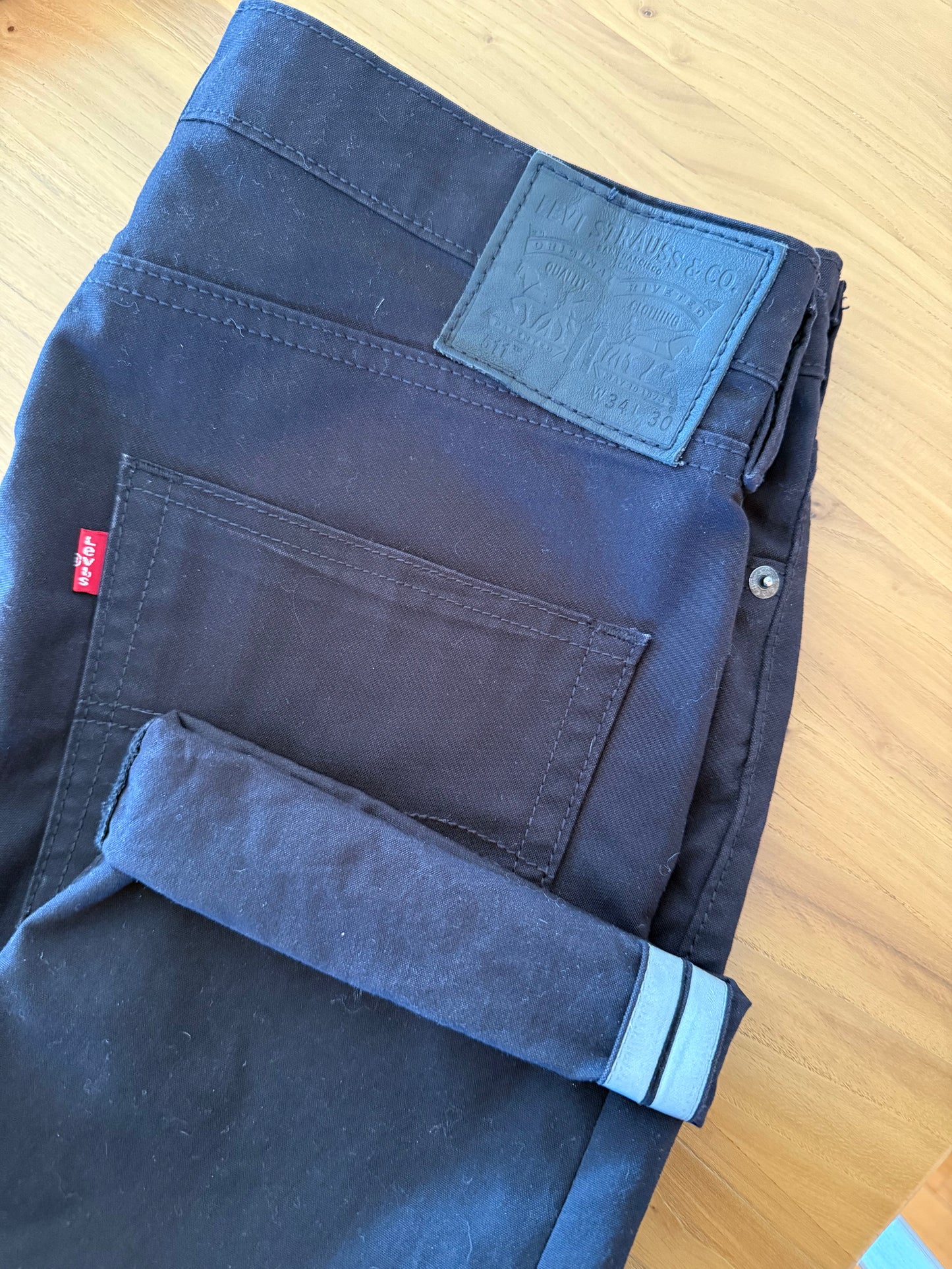 Close-up of Levis Commuter reflective cuff on black water repellent 511 jeans