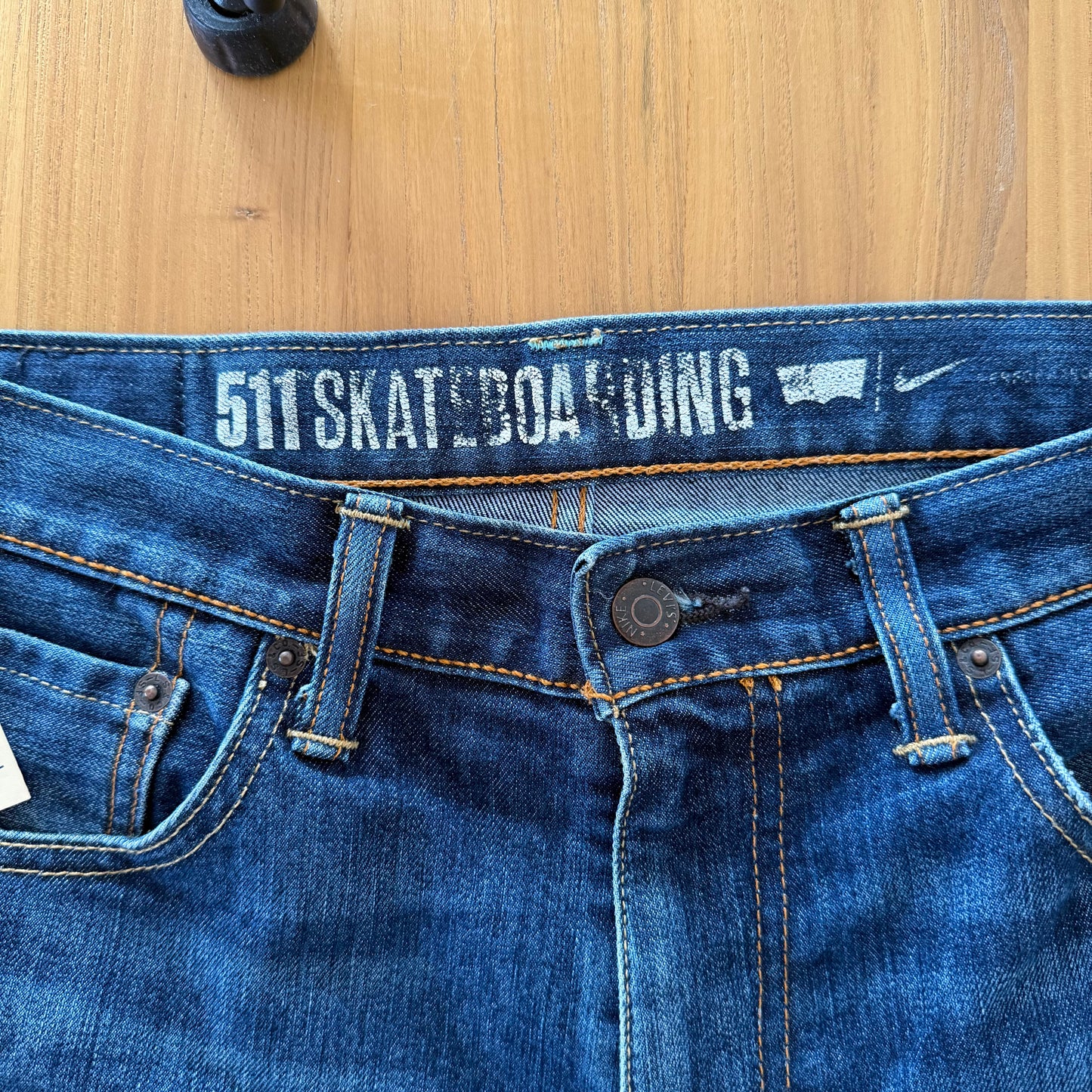 Close-up of NikeSB branding on blue Levis 511 skateboard collaboration jeans