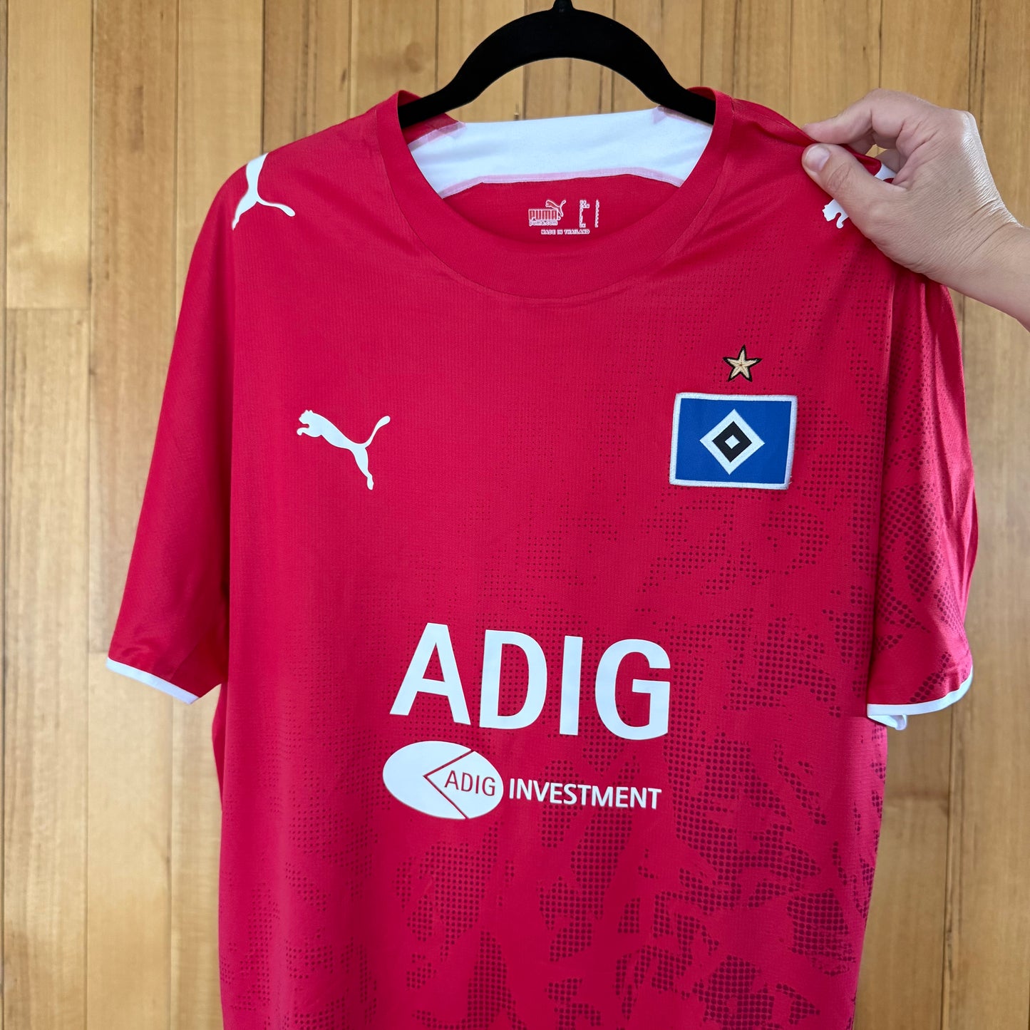 Close-up of Hamburger SV club details on red Puma football jersey