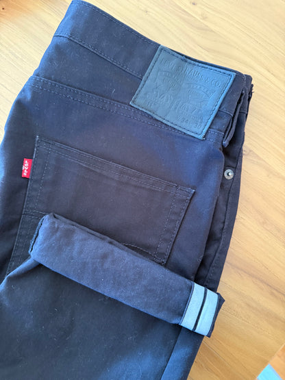 Close-up of Levis Commuter reflective cuff on black water repellent 511 jeans