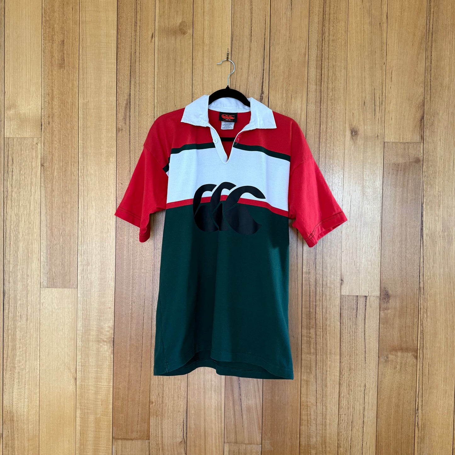 Canterbury Rugby Jersey in green, red and white with black print - front view