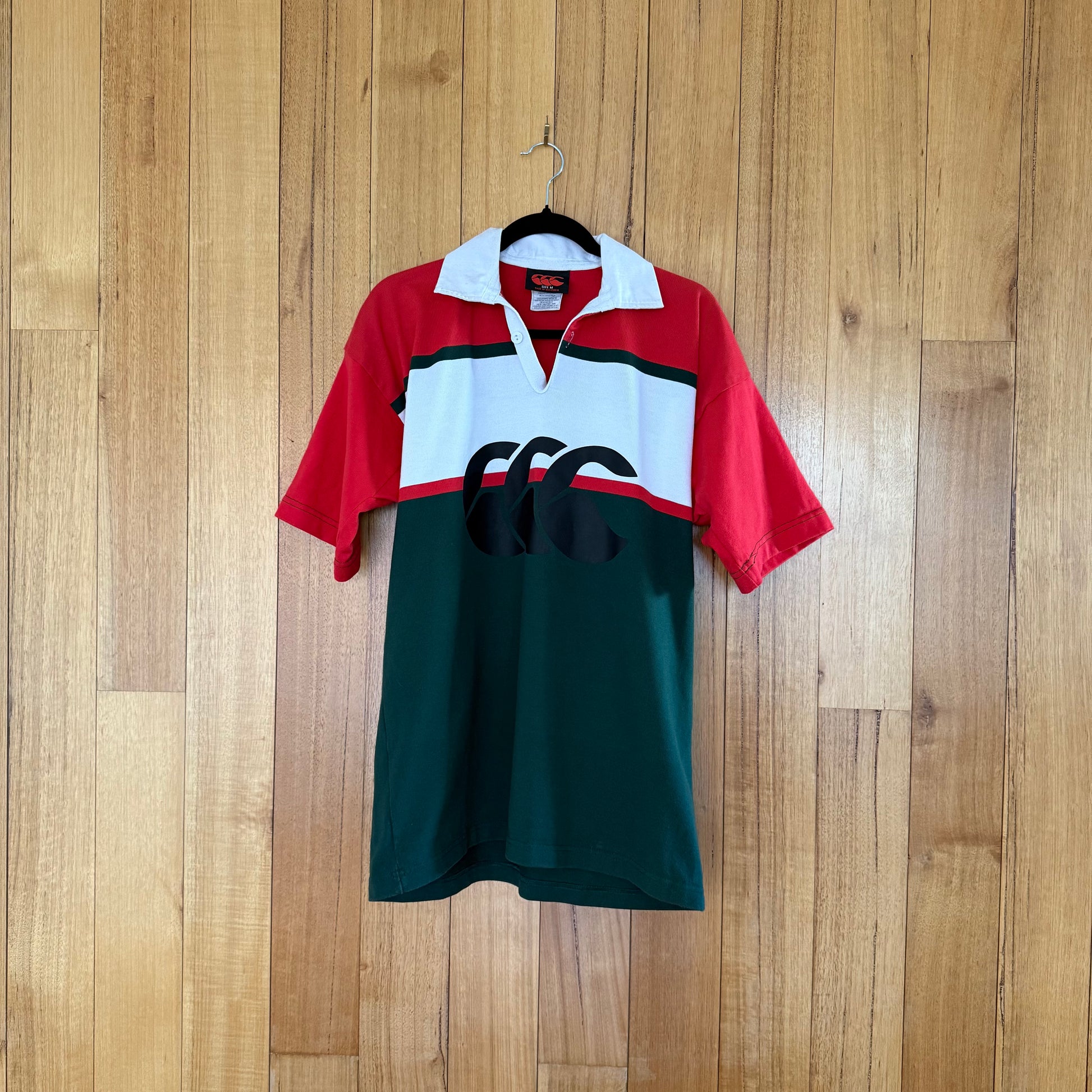 Canterbury Rugby Jersey in green, red and white with black print - front view