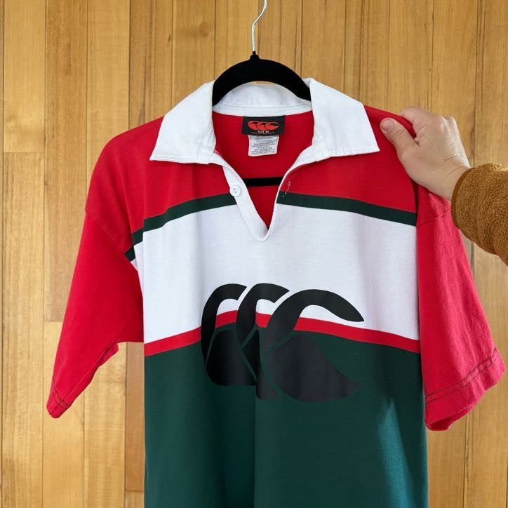 Close-up of iconic CCC Canterbury logo on green, red and white rugby jersey