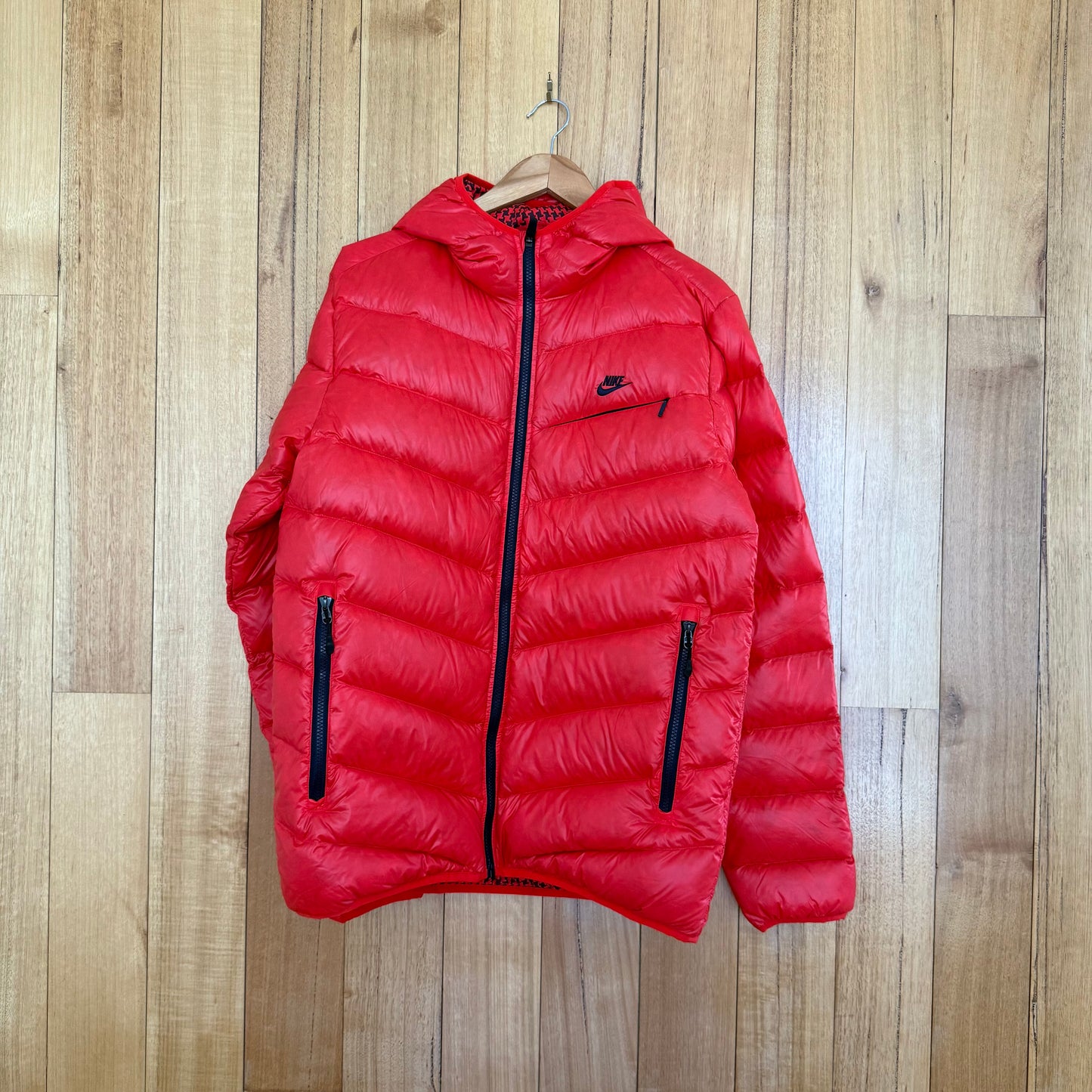 Nike Sportswear goose down puffer jacket in red with black print detail, premium down insulation, Fall 2010 release, pre-owned condition