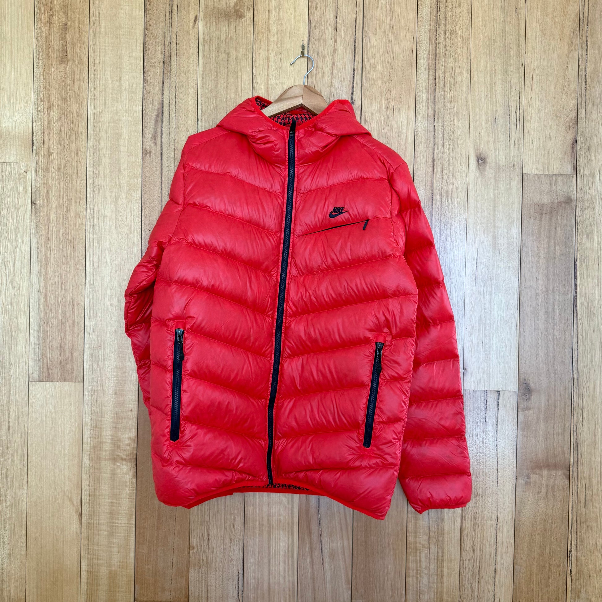 Nike Sportswear goose down puffer jacket in red with black print detail, premium down insulation, Fall 2010 release, pre-owned condition