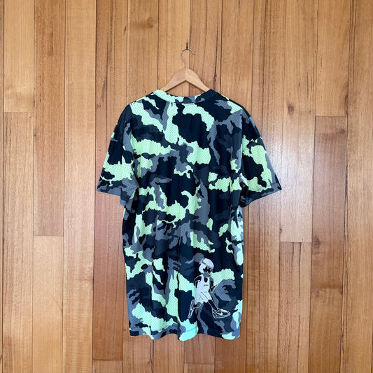 Nike Sportswear mesh camo t-shirt back view showing green/yellow camouflage pattern from Fall 2018 collection
