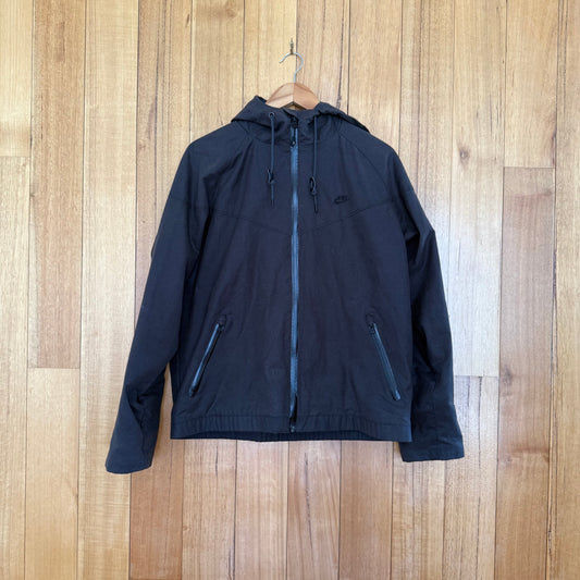 Nike Track & Field oilskin jacket in brown with black print detail, premium oilskin construction, Fall 2012 release, pre-owned condition