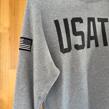 Close-up detail of dark grey print on Nike USATF grey crew sweatshirt
