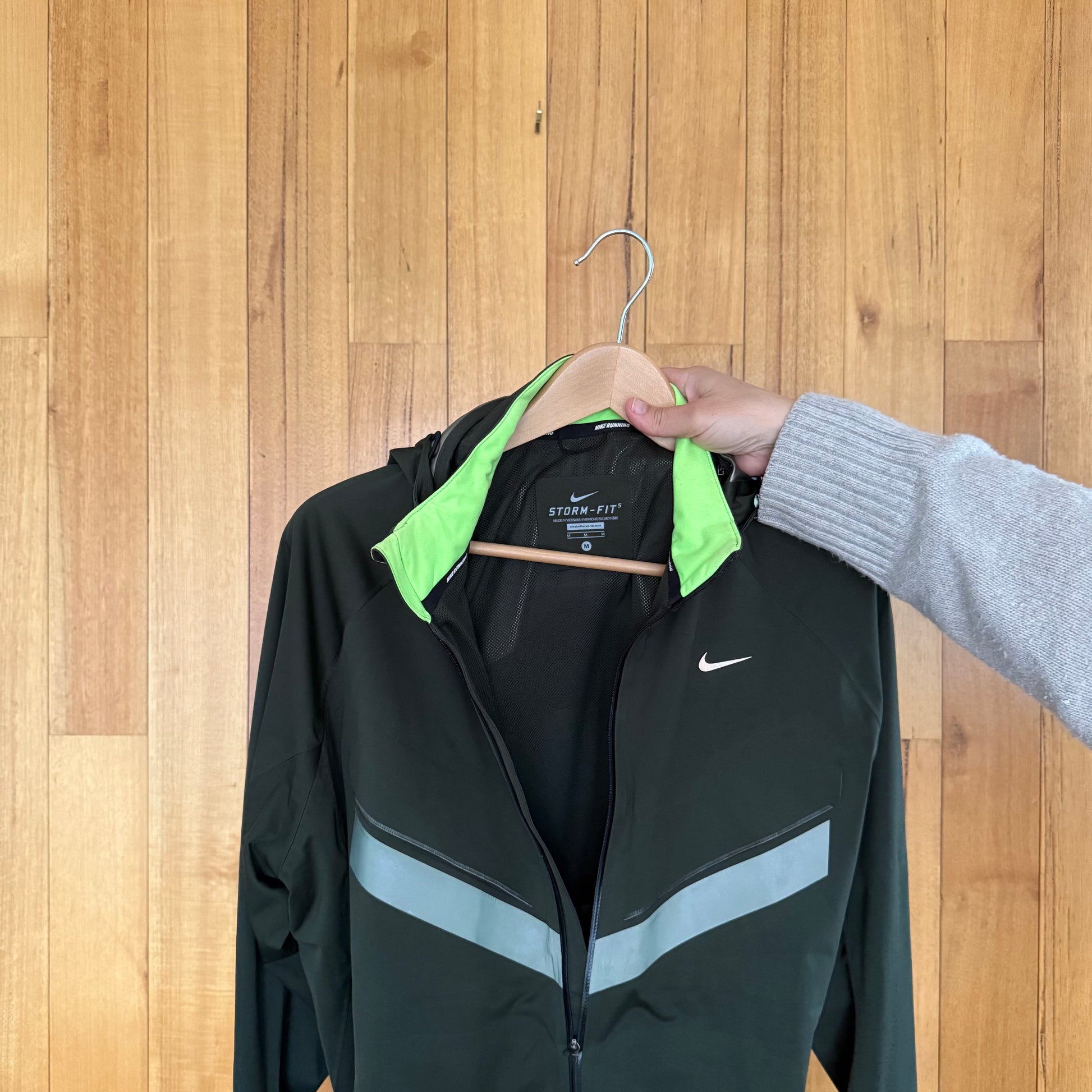 Label detail on green Nike Vapor Storm-Fit running jacket