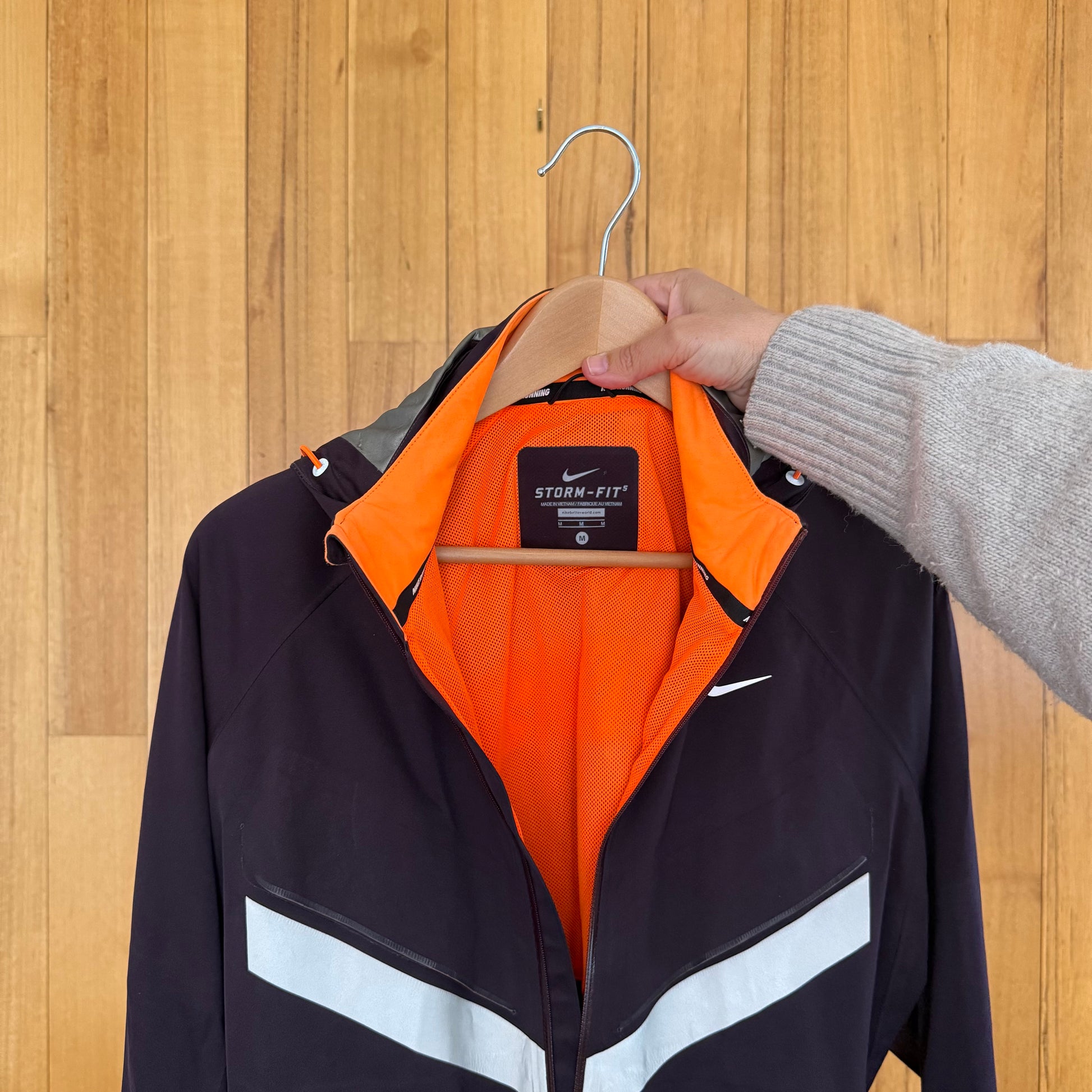 Label detail on maroon Nike Vapor Storm-Fit running jacket