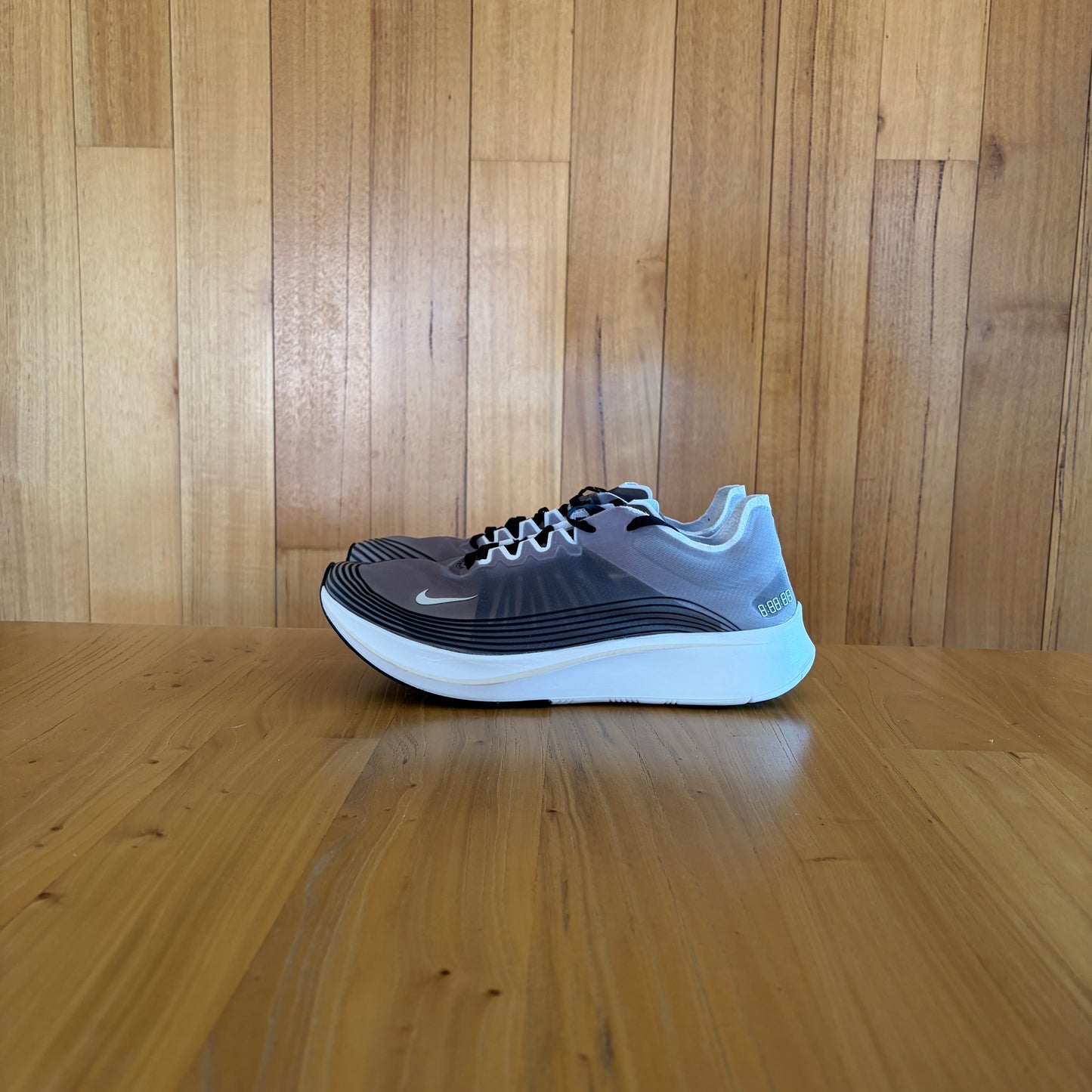 Nike Zoom Fly SP Black running shoe with semi-translucent upper, light bone and white accents, stopwatch heel graphic, new without box
